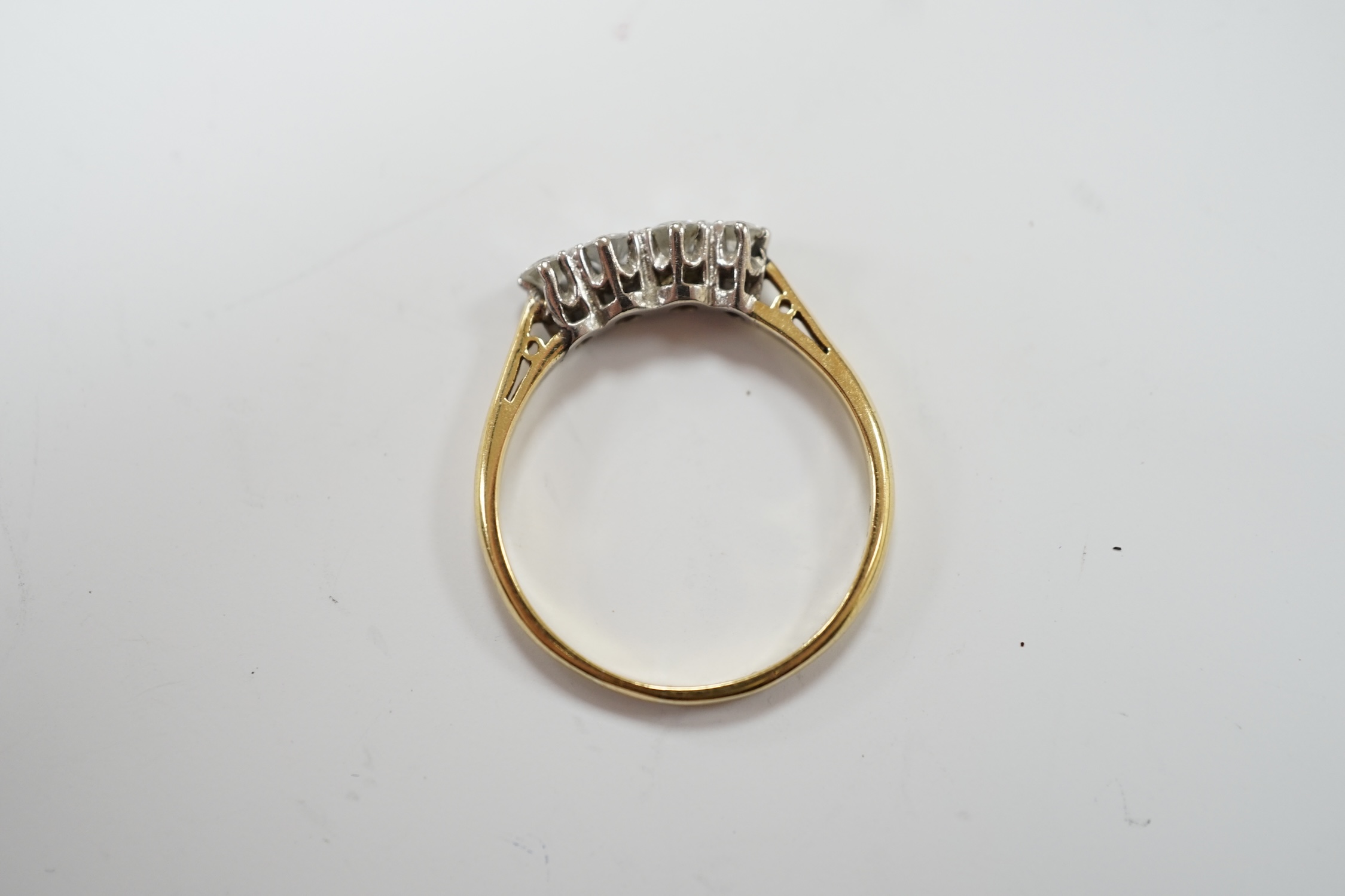 An 18ct, plat and four stone diamond set half hoop ring, size S, gross weight 2.8 grams.